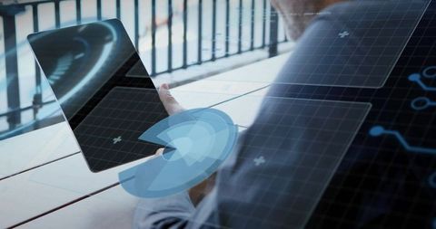 Businessman holding tablet displaying augmented reality interface on balcony terrace