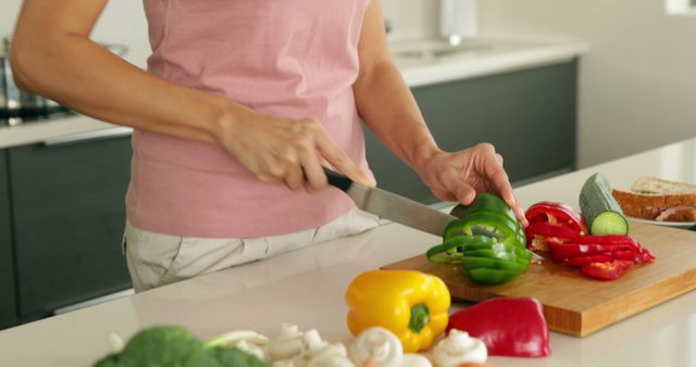 Person Cutting Bell Peppers in Modern Kitchen - Download Free Stock Images Pikwizard.com