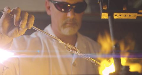 Glassblower Crafting with Fire in Workshop Celebration