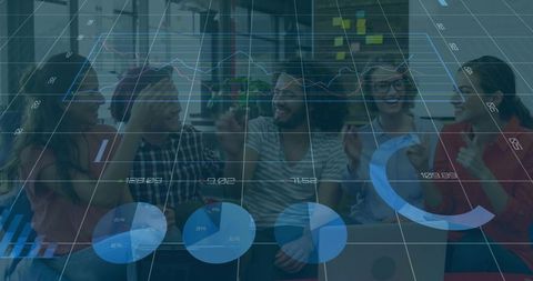 Young diverse startup team celebrating data-driven success with laptop and analytics