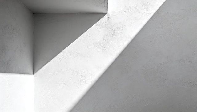 Minimalist plaster corner casting sharp diagonal light and shadow, textured architectural geometry