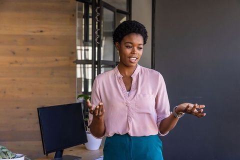 Female Leader Speaking Confidently in Modern Office