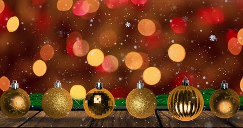 Golden Baubles with Bright Bokeh and Snowflakes