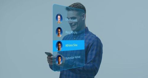 Man holding smartphone viewing holographic contacts list with blue highlighted contact