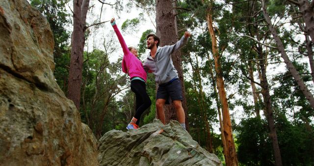 Young Couple Celebrating Top of Rock in Forest - Download Free Stock Images Pikwizard.com