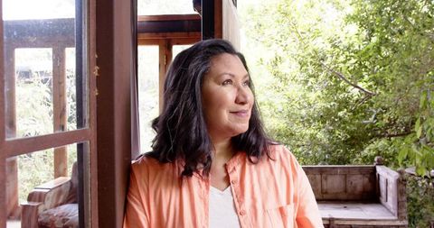 Mature Woman Relaxing on Rustic Porch in Nature