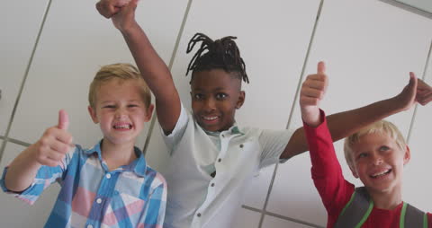 Diverse Boys Smiling and Gesturing Enthusiastically at School