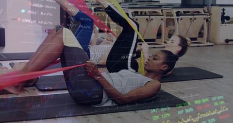 Women Exercising with Resistance Band in Gym with Stock Projections Overlay