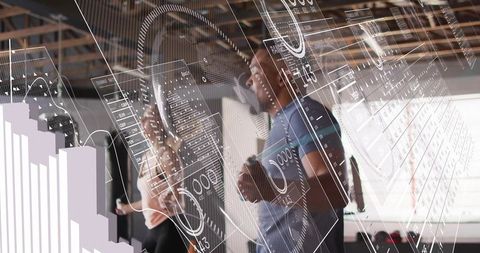 Business team analyzing live data dashboards and visual analytics in modern open office