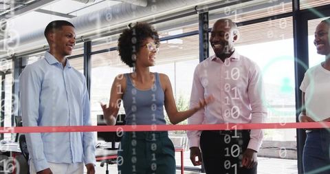 Team celebrating ribbon-cutting launch in modern office with digital binary overlay