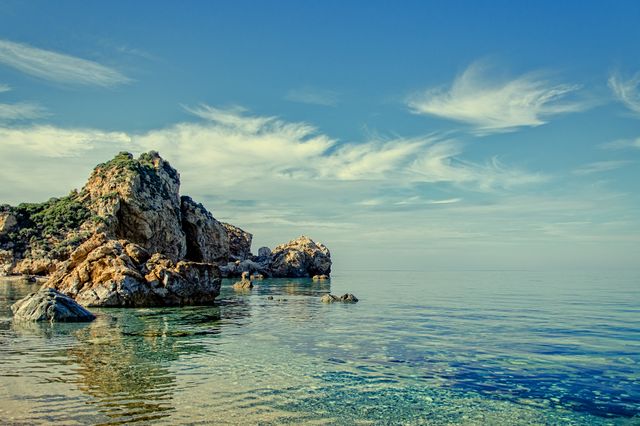 Cliff and Rock Formations on Calm Body of Water during Daytime - Download Free Stock Photos Pikwizard.com