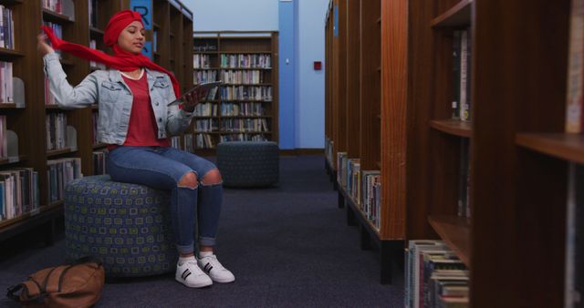 Young Woman Reading Book in Library, Relaxing and Smiling - Download Free Stock Images Pikwizard.com