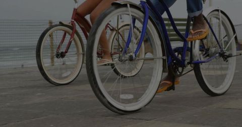 Couple Cycling by Ocean Promenade on Vintage Bikes