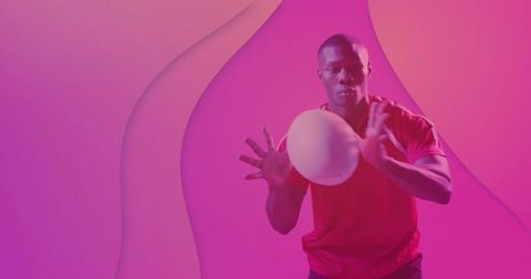 Athlete in motion catching ball against vibrant pink background