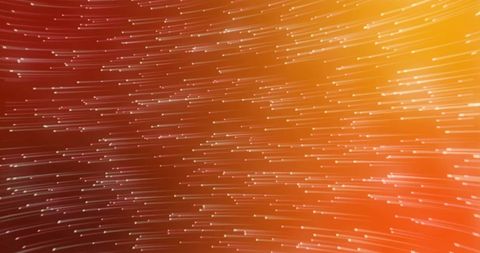 Dynamic light trails on vibrant orange background