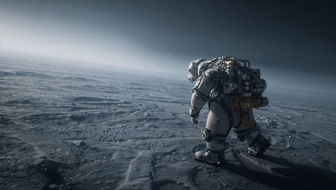 Solitary astronaut traversing alien barren plain in heavy extravehicular suit carrying life pack