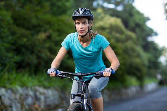 Confident woman cycling on the road