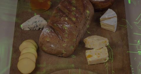Rustic artisan loaf with mixed cheeses and honey on wood board with green tech overlay