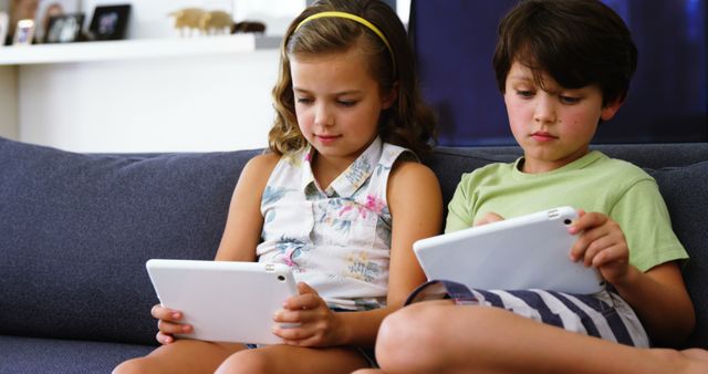 Children Using Tablets on Couch - Download Free Stock Images Pikwizard.com