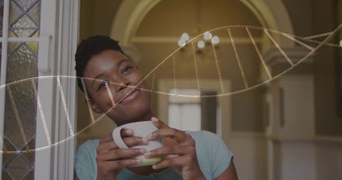Contemplative woman holding mug in arched hallway with dna strand overlay, wellness theme