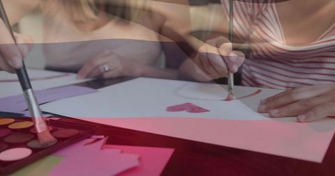 Children engaged in art painting hearts