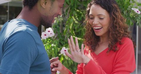 Ecstatic woman showing engagement ring after proposal
