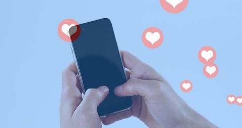 Hands Holding Smartphone with Floating Heart Icons on Blue Background