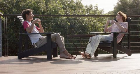 Relaxed Couple Enjoying Coffee on Sunny Balcony