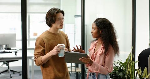 Diverse colleagues discussing ideas in contemporary office space