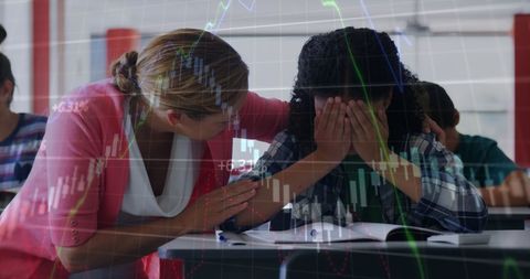 Supportive Teacher Comforting Upset Student in Classroom Setting