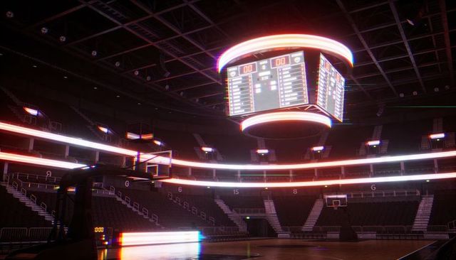 Suspended led ring jumbotron illuminating empty basketball court in modern arena