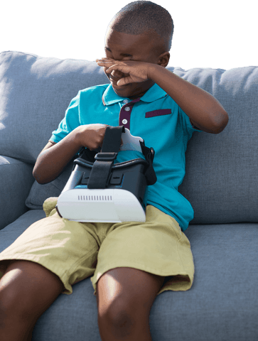 Boy Rubs Eyes Holding VR Headset on Couch - Download Free Stock Videos Pikwizard.com
