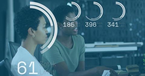 Women collaborating at shared office desk with data overlays showing analytics progress