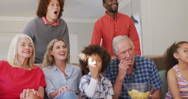 Excited Family Watching TV Together Enjoying Snacks at Home - Download Free Stock Images Pikwizard.com