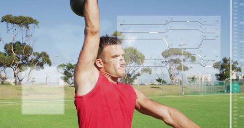 Athlete performing kettlebell overhead press with fitness analytics overlay in outdoor park