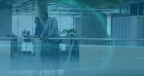 Professional Colleagues Standing in Office Corridor Engaging in Conversation