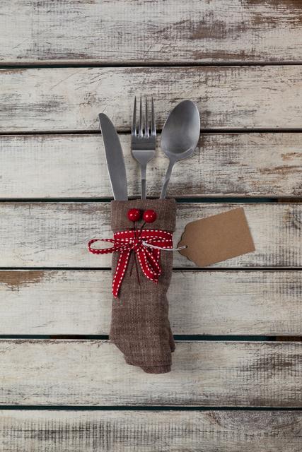 Cutlery tied up with socks on a plank
