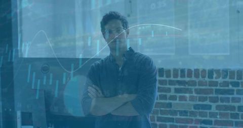 Confident data analyst standing arms crossed in workspace with candlestick chart overlay