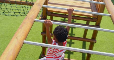 Young Boy Hanging on Playground Ladder Outdoors - Download Free Stock Images Pikwizard.com