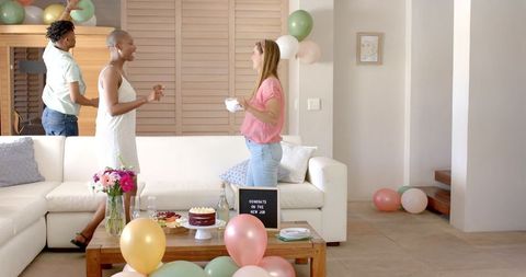 Friends Celebrating with Balloons and Cake for New Job