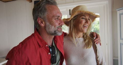 Happy Mature Couple Arriving at Hotel Room Ready for Vacation