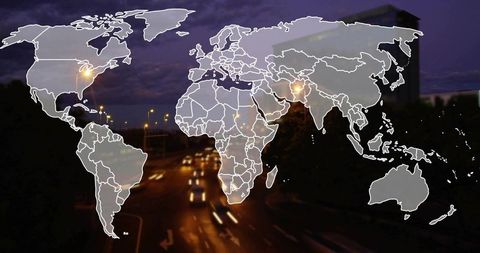 Overlaying world map outlining global connectivity over urban night traffic and light trails