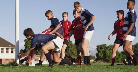 Teen Rugby Teams Competing on Field During Sunny Day