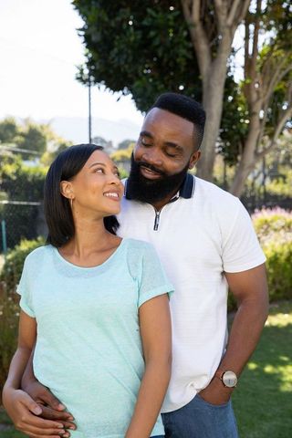 Joyful Couple Embracing Togetherness in Serene Backyard Setting