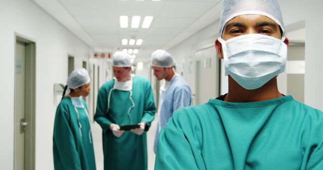 Confident Surgeon with Colleagues in Background at Hospital - Download Free Stock Images Pikwizard.com