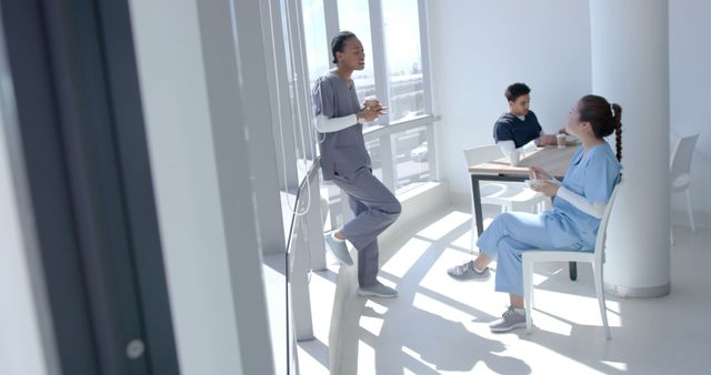 Healthcare Professionals Taking Break in Bright Hospital Cafeteria - Download Free Stock Images Pikwizard.com