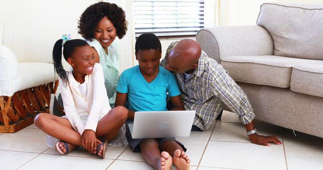 Happy Family of Four Using Laptop Together at Home - Download Free Stock Images Pikwizard.com