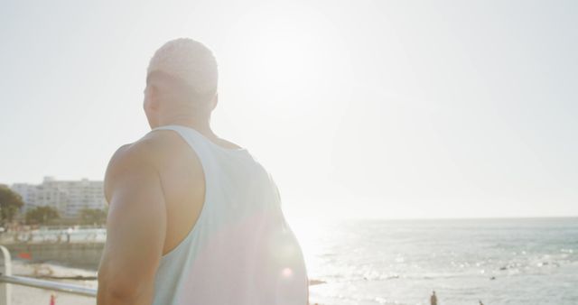 Man Enjoying Scenic Coastal View at Sunny Beach - Download Free Stock Images Pikwizard.com