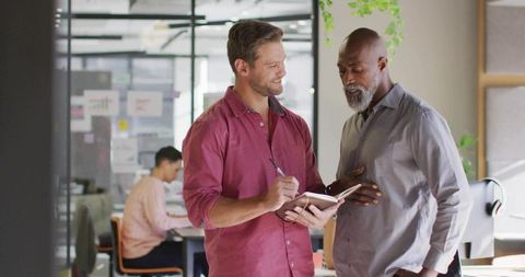 Office professionals collaborating over work ideas