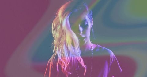 Woman in artistic neon portrait with color light projections